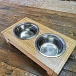 dog feeding station, with two bowls, sat on a table