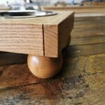 dog feeding station sat on a wooden table