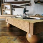 Artisan solid oak dog fed station sitting on a wooden table