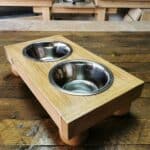 dog feeding station upon a solid wood table.